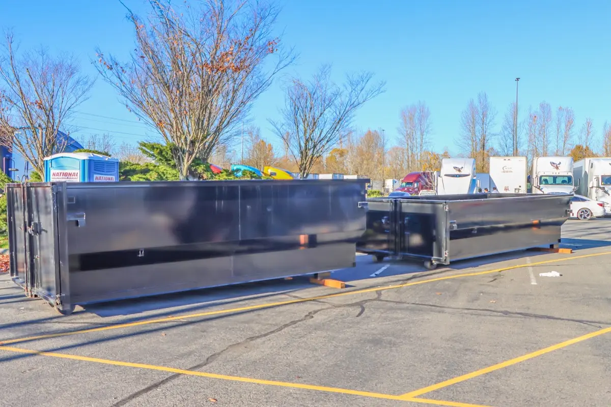 Professional dumpster rental service with roll-off container on residential driveway in La Feria